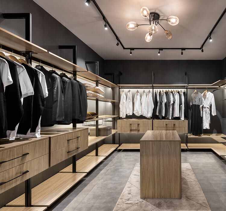 Top advantages of modular wardrobes you should know 1 A stylish walk-in closet with wooden shelves displaying clothes, designed with the alea modular wardrobe concept.